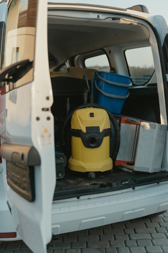 yellow-and-black-car-door-6196235 A well-organized cleaning van with equipment in the cargo area.